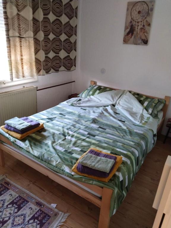 Postel nebo postele na pokoji v ubytování Bagins Apartman