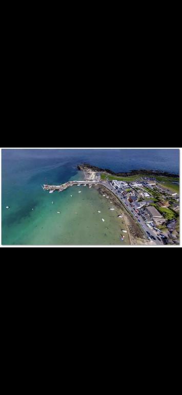 an aerial view of a beach with boats in the water at The Lifeboat & Seaview Terrace in Skerries