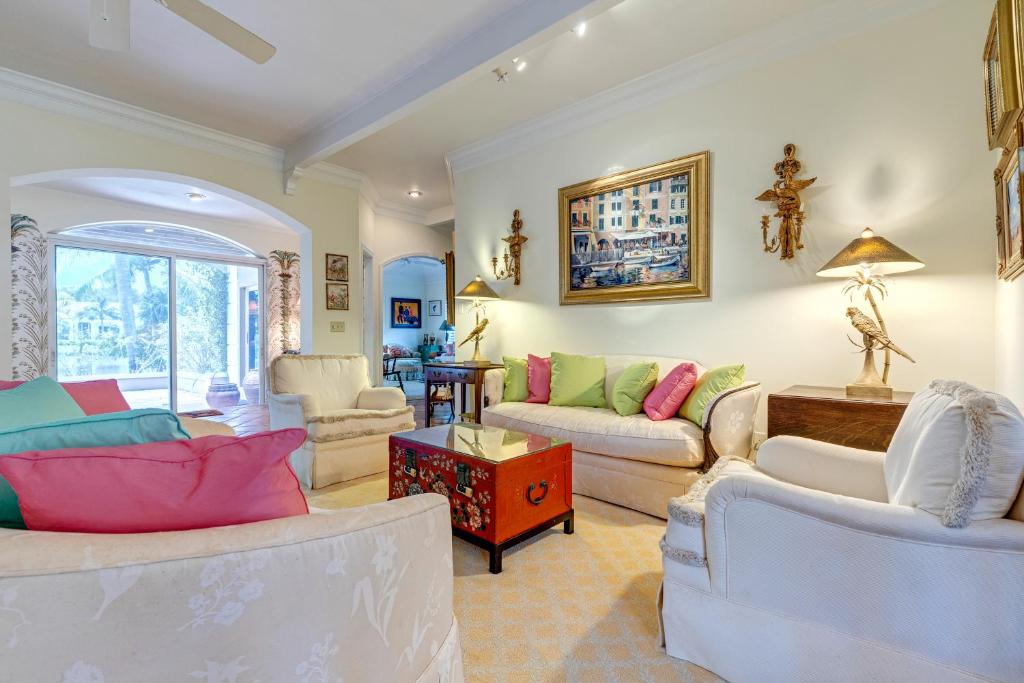 a living room with two couches and a table at Indian Harbor Haven in Vero Beach