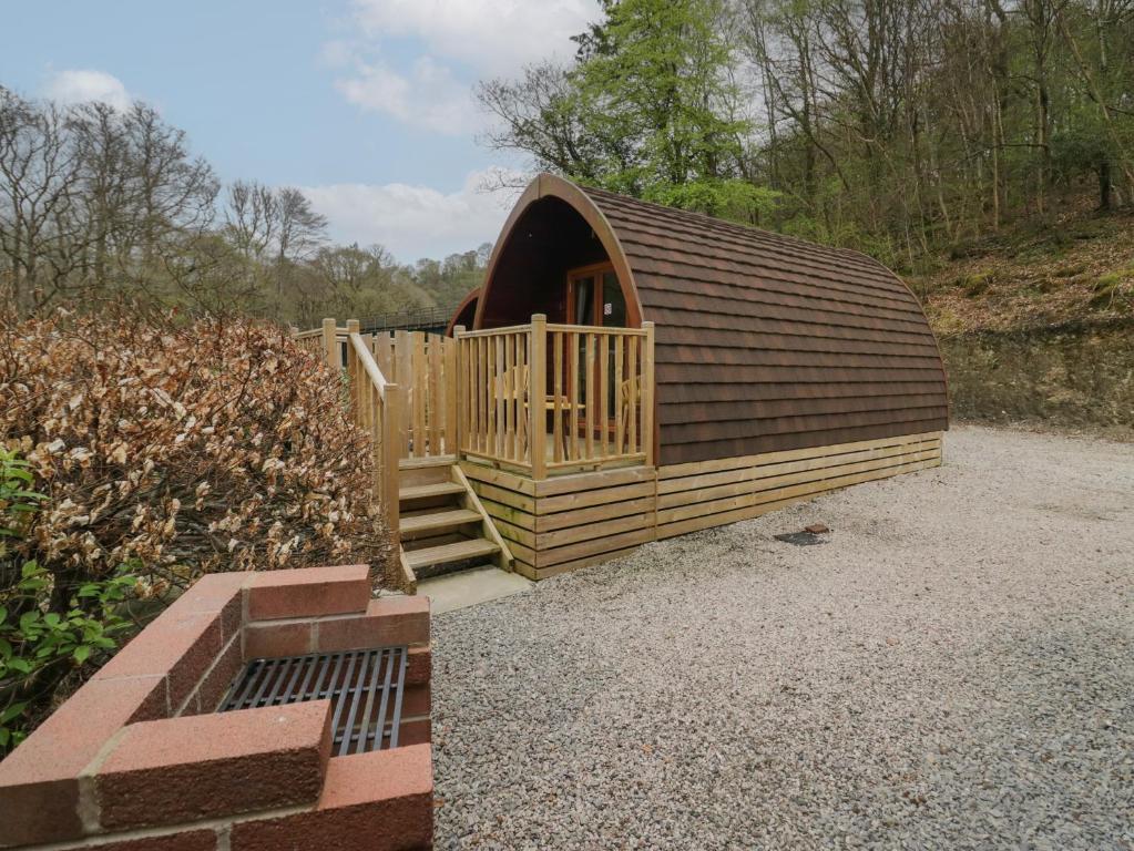 a small wooden cabin with a wooden door at Pod No 6 in Keswick