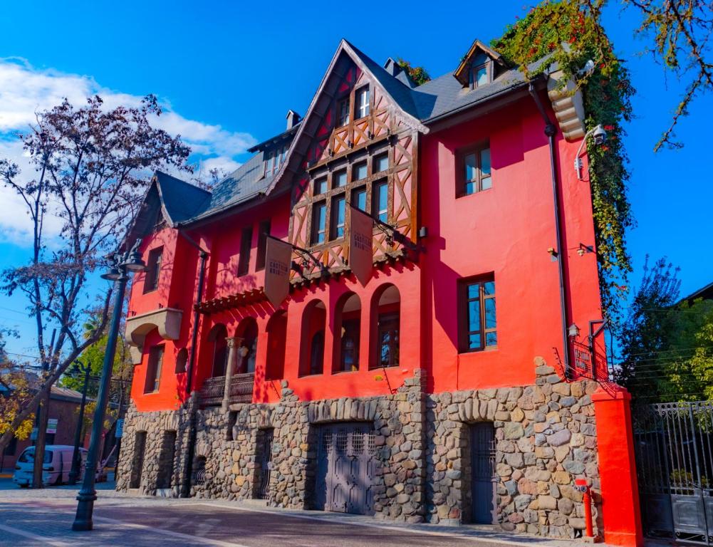 a red building on a street at Hotel Boutique Castillo Rojo in Santiago