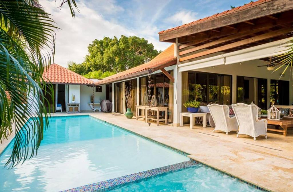 eine Villa mit einem Pool und einem Haus in der Unterkunft Sunny Vacation Villa No 88 in San Rafael del Yuma