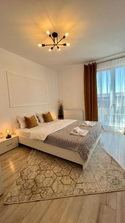 a bedroom with a large bed with a ceiling fan at The Nest in Floreşti