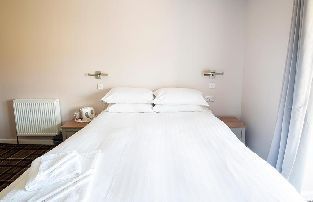 Postel nebo postele na pokoji v ubytování Poseidon Inn
