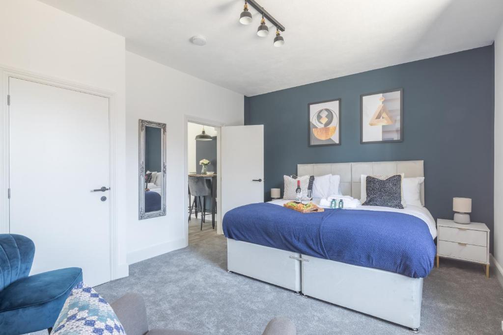 a bedroom with a bed and a blue wall at Radcliffe Studios in Wolverton