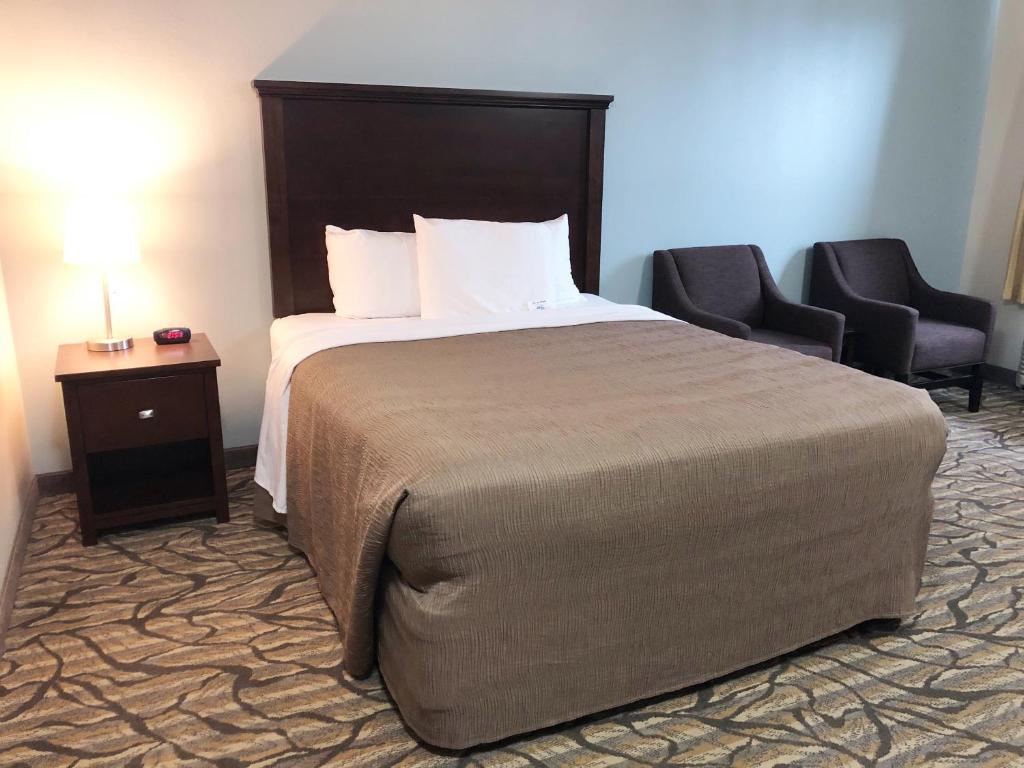 Postel nebo postele na pokoji v ubytování Aptel Studio Hotel