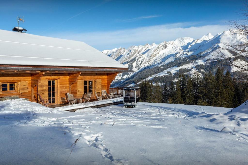 a log cabin in the mountains in the snow at Chalet Sisar - OVO Network in La Clusaz