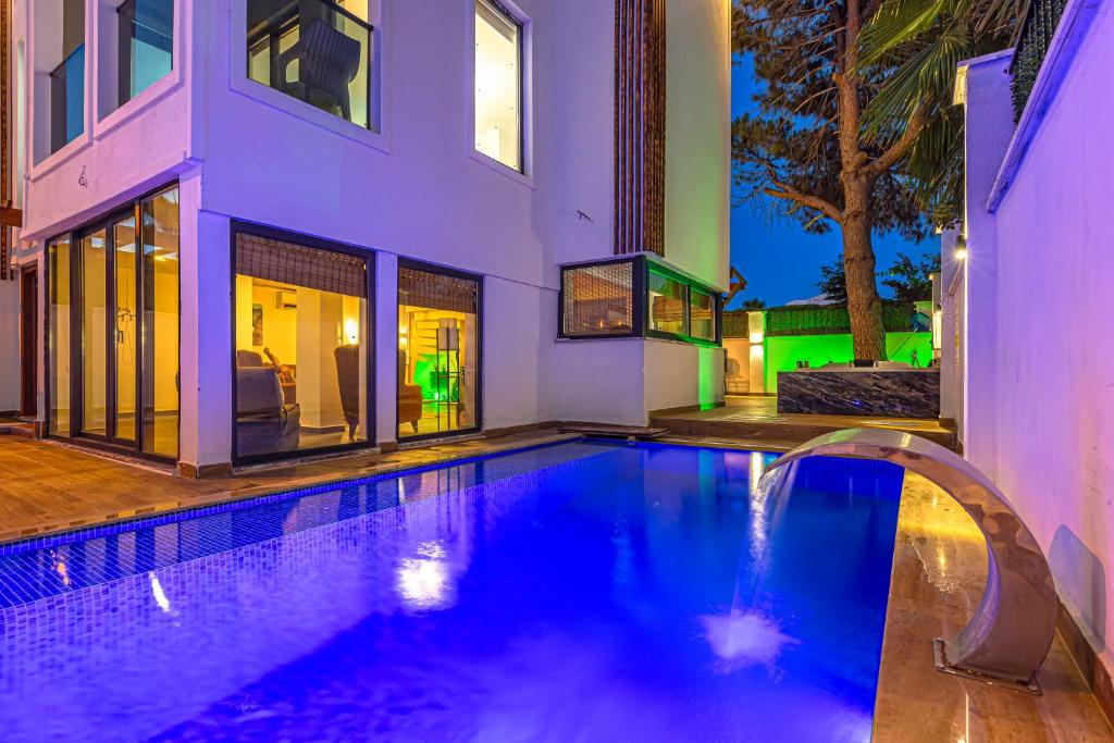 a swimming pool in front of a house at Private & Secluded Luxury Villa Casa Pura Vida in Belek