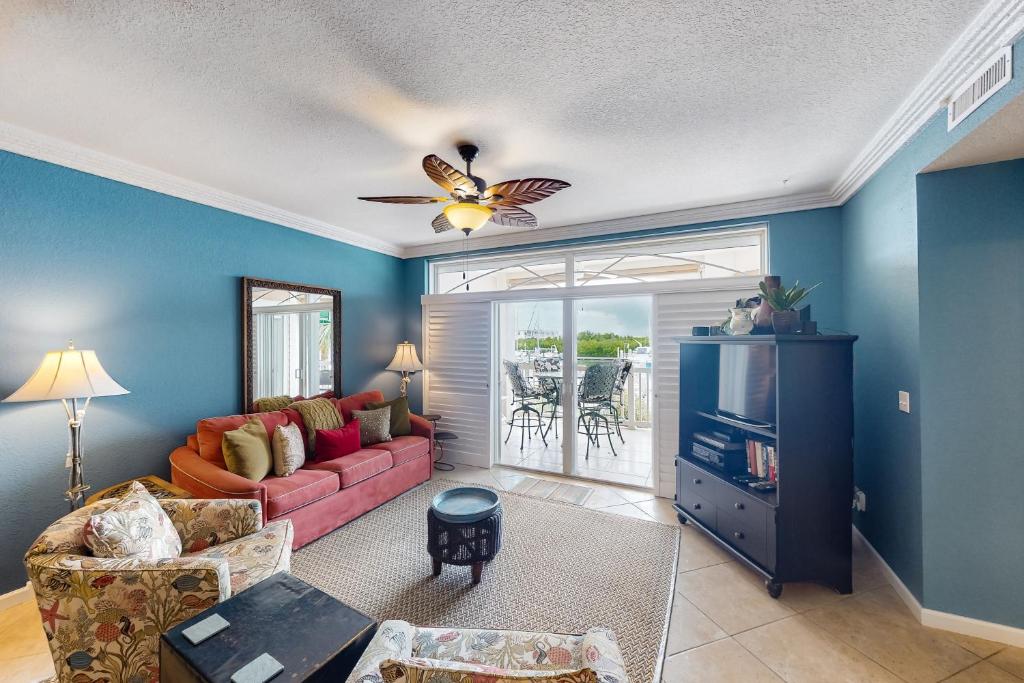 a living room with a couch and a tv at Tarpon Watch in Key West