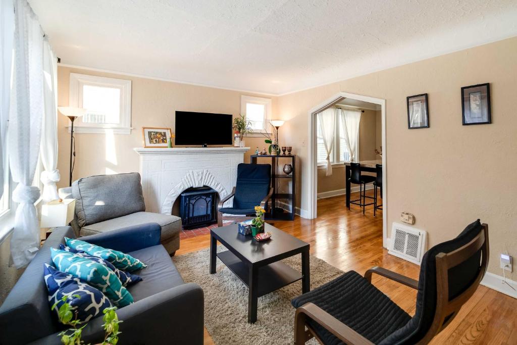 a living room with a couch and a fireplace at Spacious Ferndale Apt with Yard about half Mi to Dtwn! in Ferndale