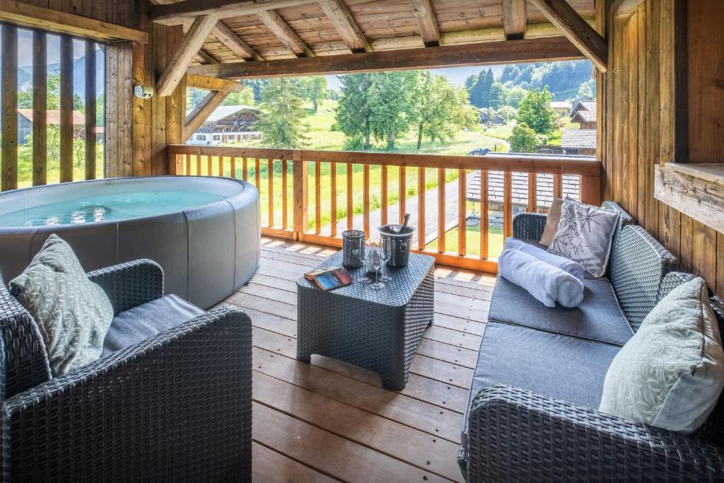 a patio with a hot tub on a deck at Chalet Pativerdan - OVO Network in Samoëns