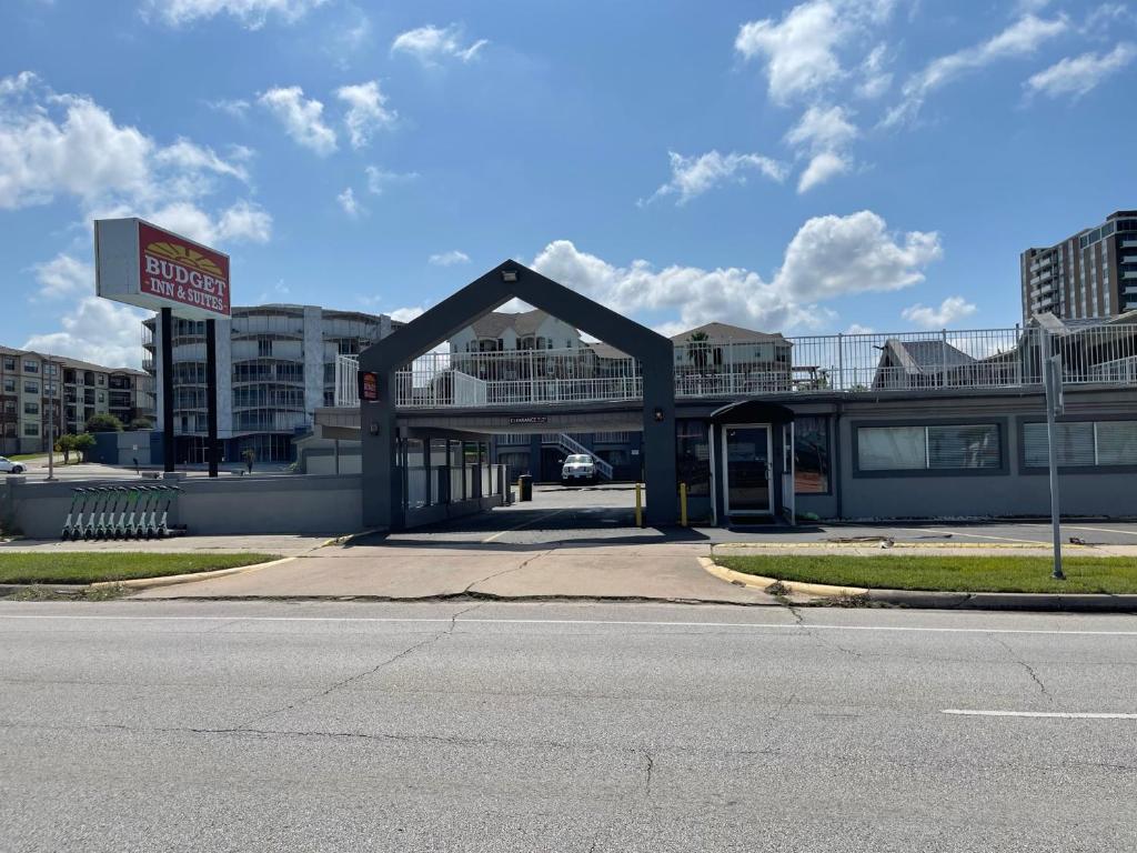 a building with a sign on the side of a street at Budget Inn and Suites Corpus Christi in Corpus Christi