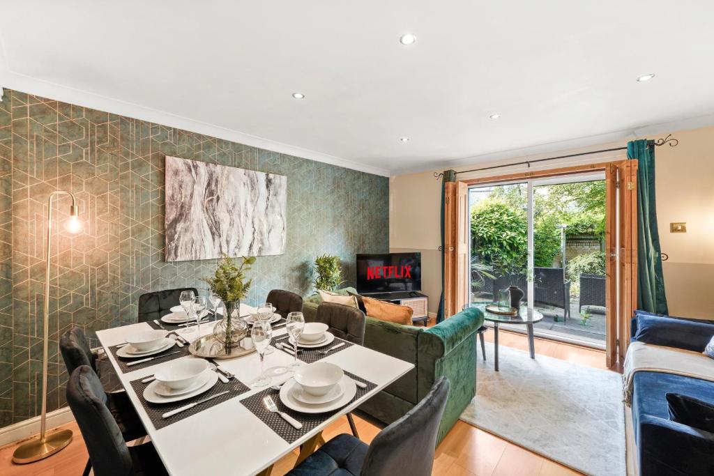 un soggiorno con tavolo e divano di Stunning Central London 2 Bed Parking & Garden a Londra