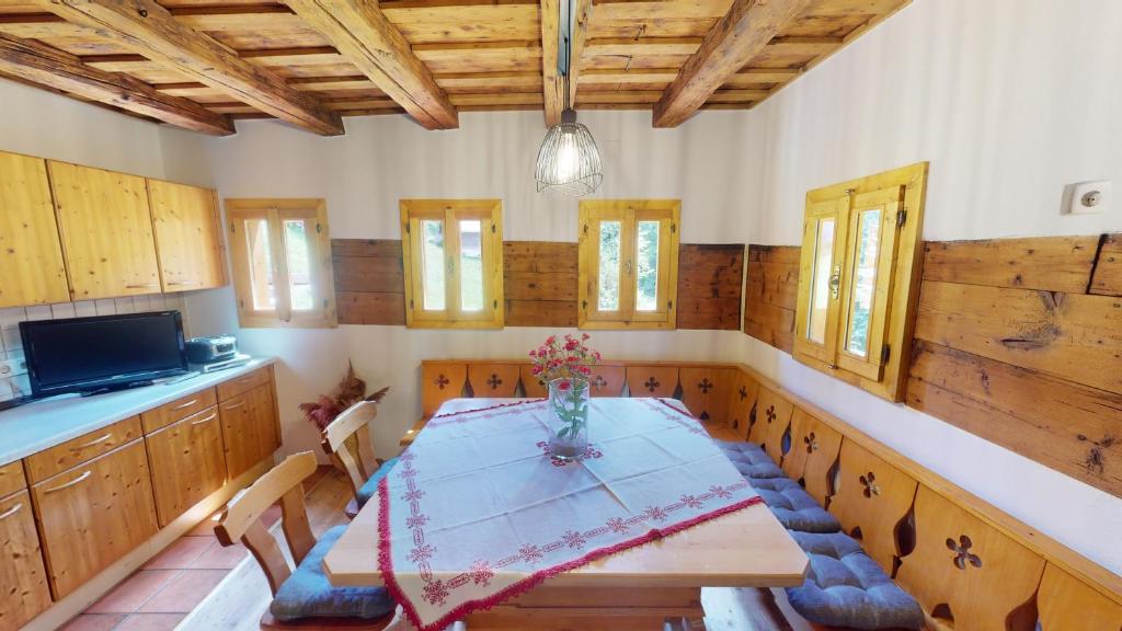 una sala da pranzo con tavolo, sedie e armadi in legno di Ferienhaus Kleissner a Nestelberg
