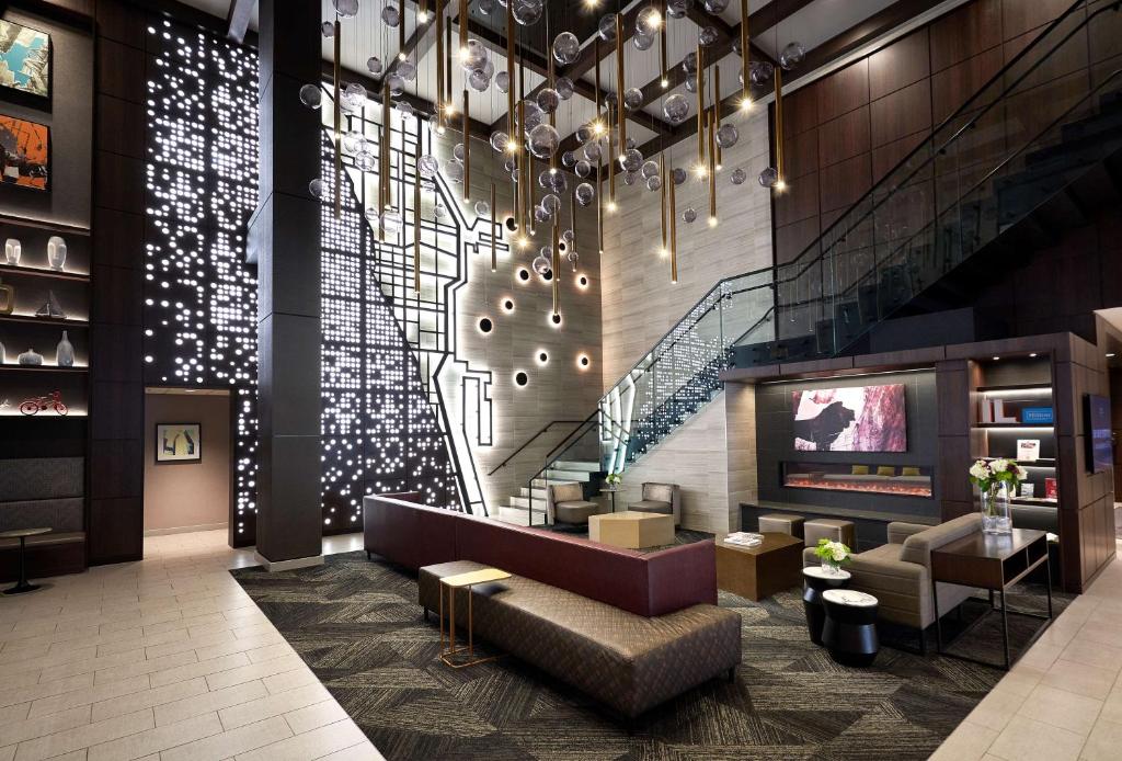 a lobby with a couch and a tv and stairs at Hampton Inn & Suites Chicago-Downtown in Chicago