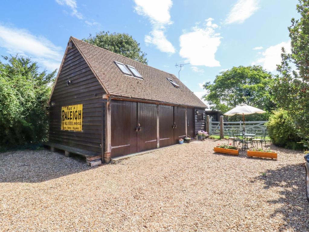 a barn with a sign on the side of it at The Studio, Horseshoe Cottage in Fulbourn