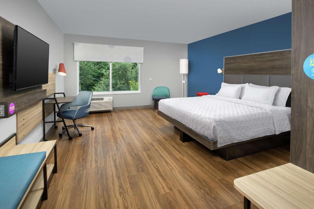 a hotel room with a bed and a desk at Tru By Hilton Mt Pleasant Charleston in Charleston