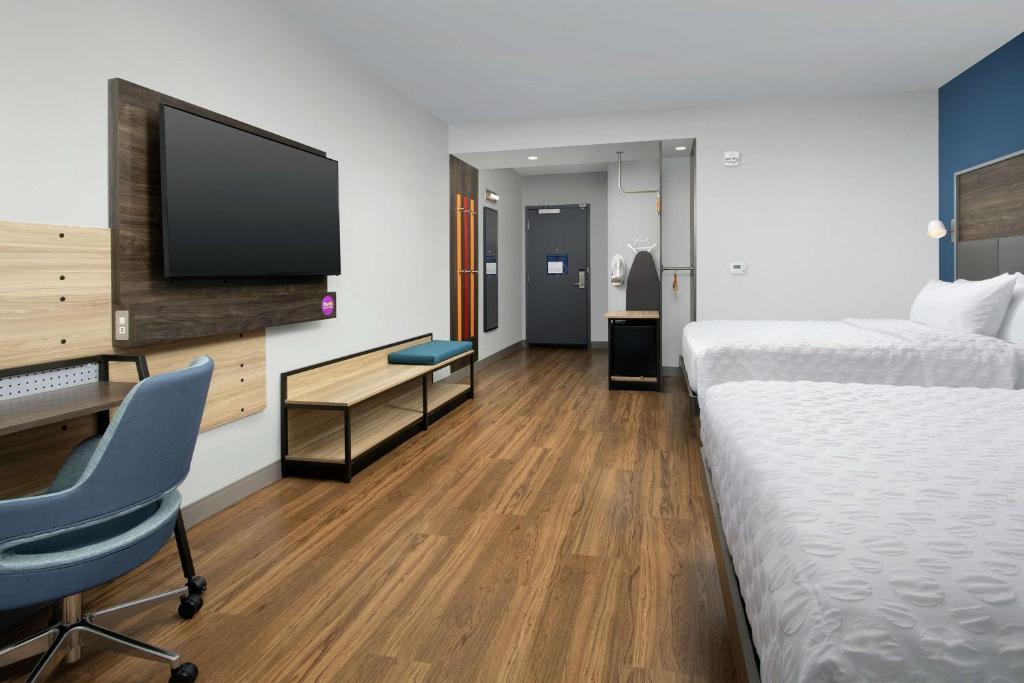 a hotel room with a bed and a desk and a tv at Tru By Hilton Mt Pleasant Charleston in Charleston