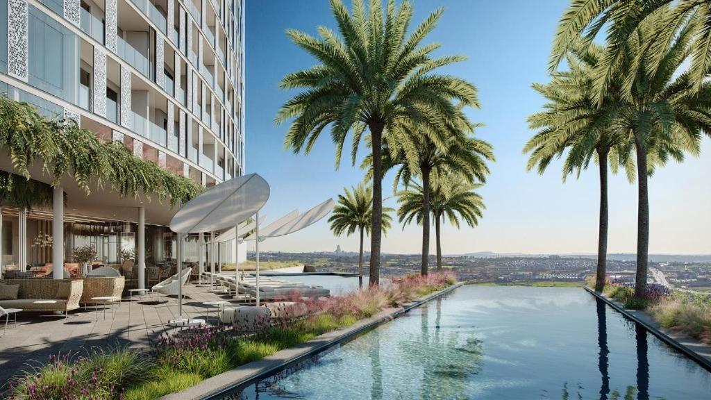 una riproduzione di una piscina con palme di Upmarket Executive Luxury Apartment a Midrand