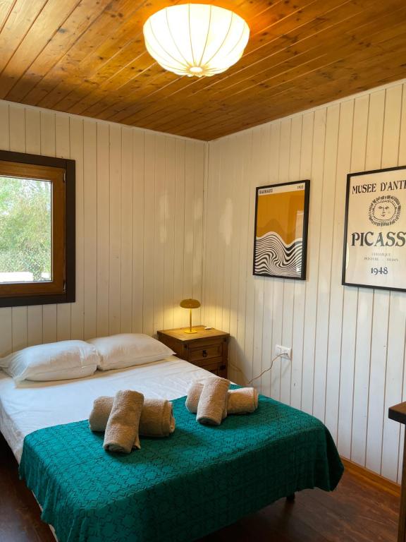 a bedroom with a bed with two towels on it at WAVEShouseTARIFA in Tarifa