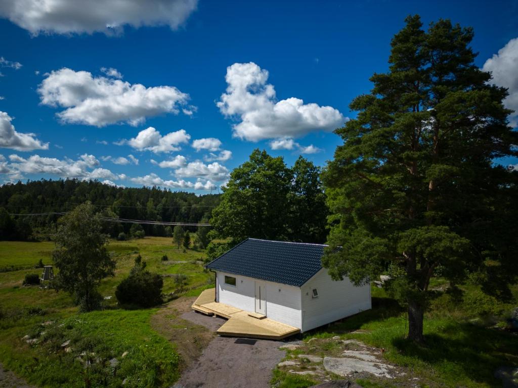a small white shed with a roof on a field at Wild Lodge in Nol