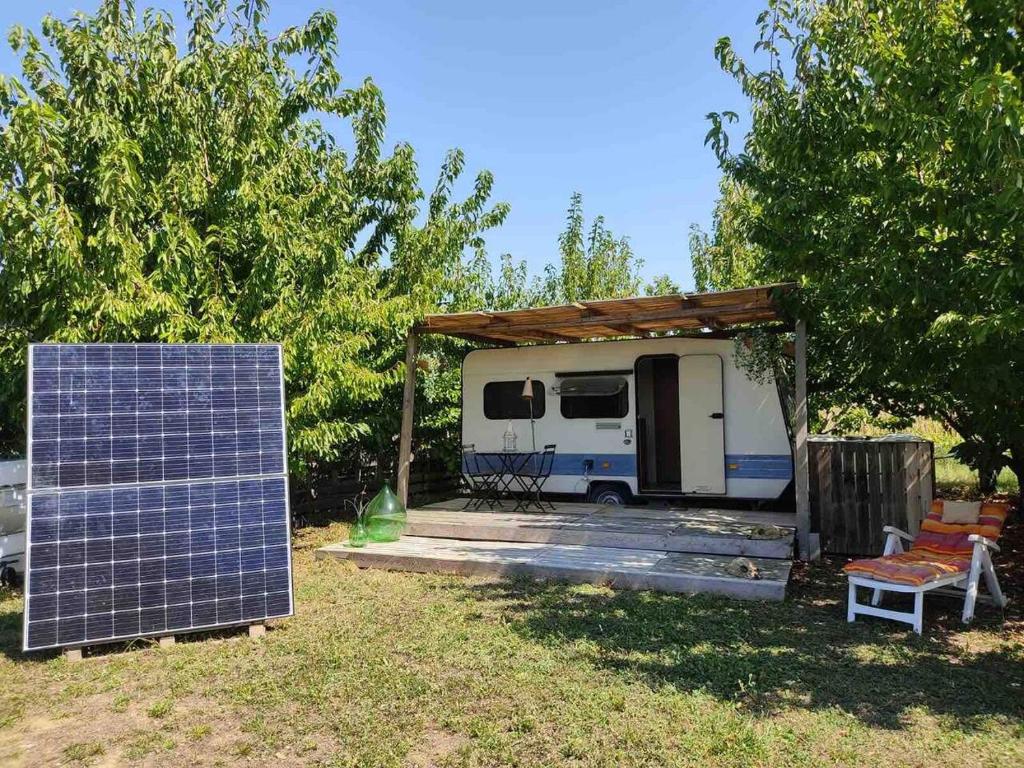 a trailer with a solar panel in front of it at Home Shanti, relax tra i ciliegi in Crespellano