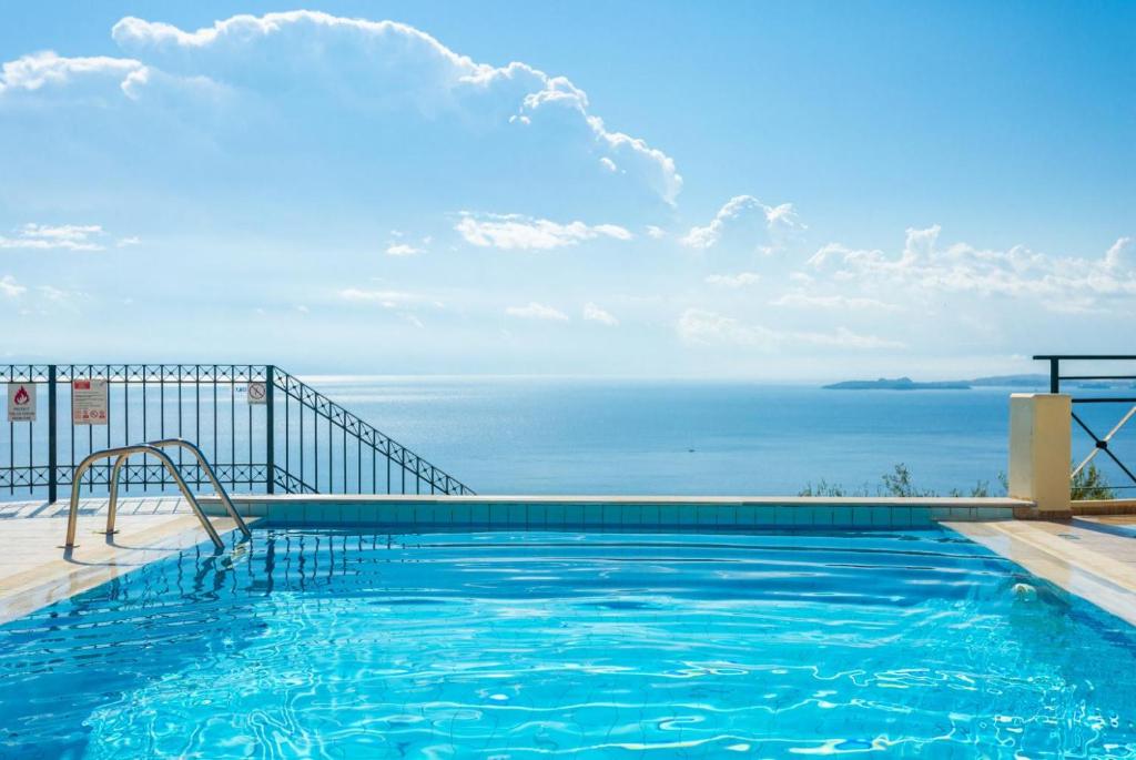 a swimming pool with a view of the ocean at Villa Georgios in Plátonas