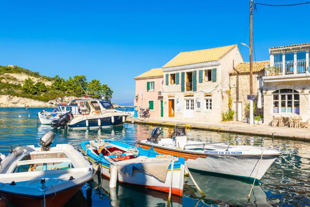 a group of boats are docked in a harbor at Spiros Jetty House in Longos