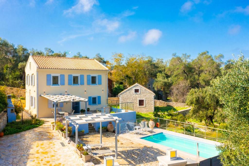 a villa with a swimming pool and a house at Villa Constadina Large Private Pool AC WiFi in Mastorátika