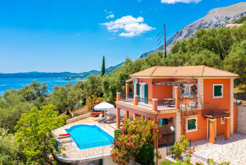a villa with a swimming pool and a view at Villa Youla in Nisaki