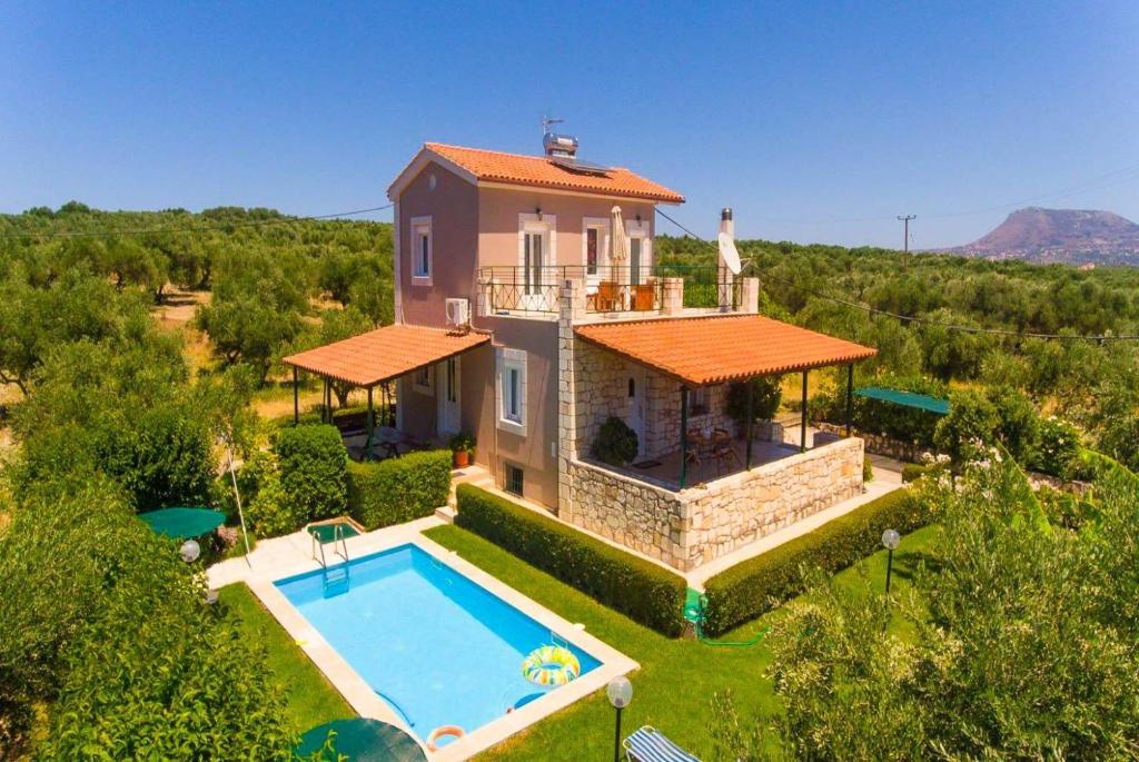 an aerial view of a house with a swimming pool at Villa Giannis in Áyios Andónios