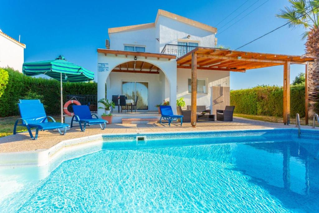 a villa with a swimming pool and a house at Argaka Sun Villa Ena in Argaka
