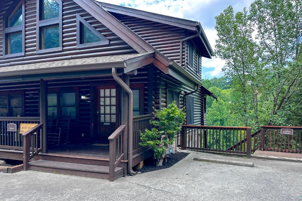 a house with a porch with a wooden fence at Reindeer Hideaway in Pigeon Forge