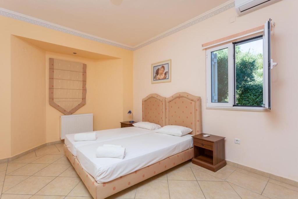 Postel nebo postele na pokoji v ubytování Villa Asimenia