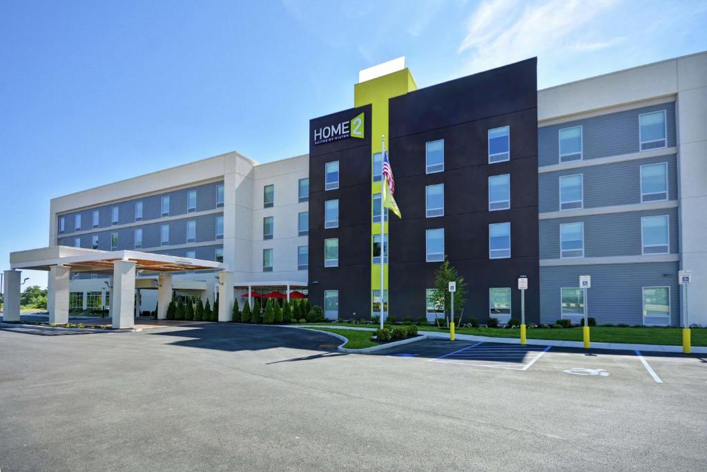 a rendering of the front of a hotel with a parking lot at Home2 Suites by Hilton Queensbury Lake George in Queensbury