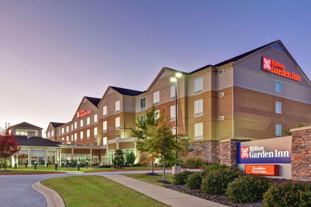 a rendering of an apartment building at dusk at Hilton Garden Inn and Fayetteville Convention Center in Fayetteville