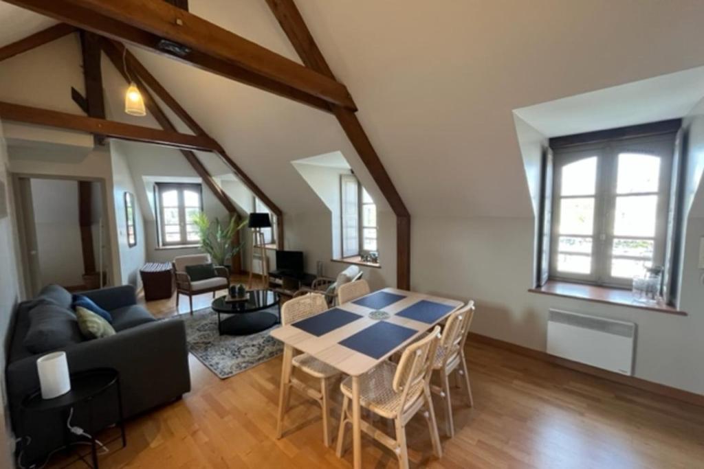 a living room with a table and a couch at Bright apartment near the heart of Vannes in Vannes