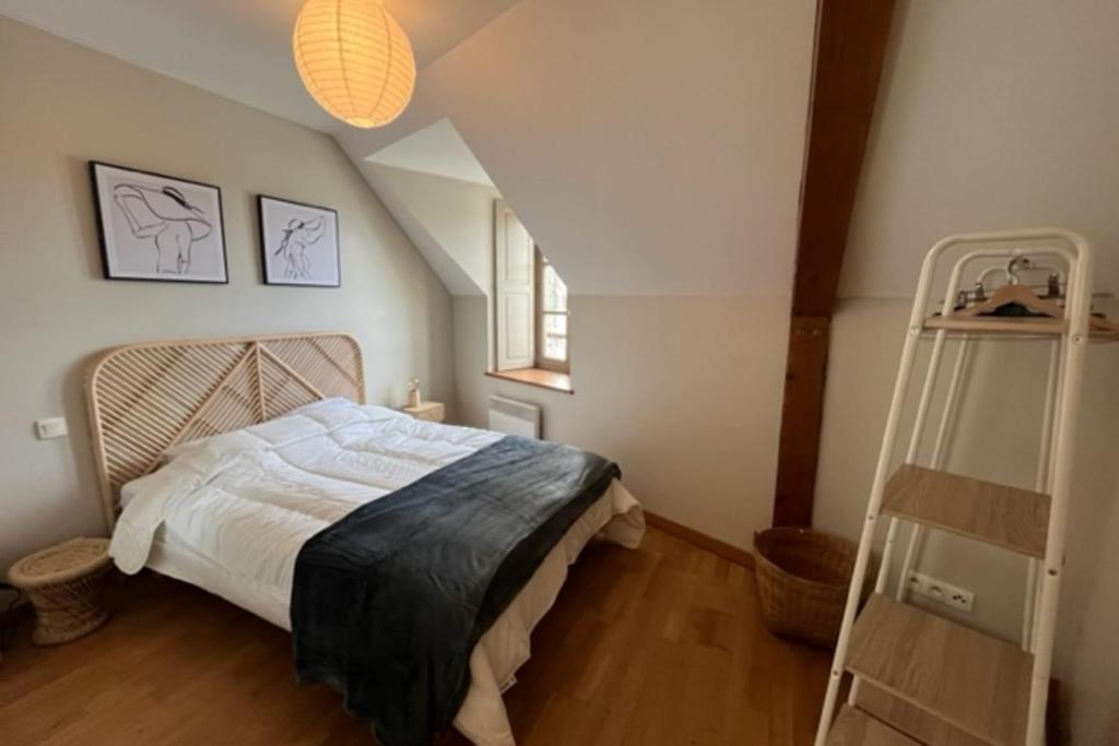 a bedroom with a large bed in a attic at Bright apartment near the heart of Vannes in Vannes