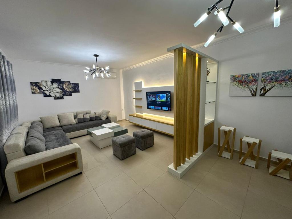 a living room with a couch and a tv at Elby Apartments in Berat