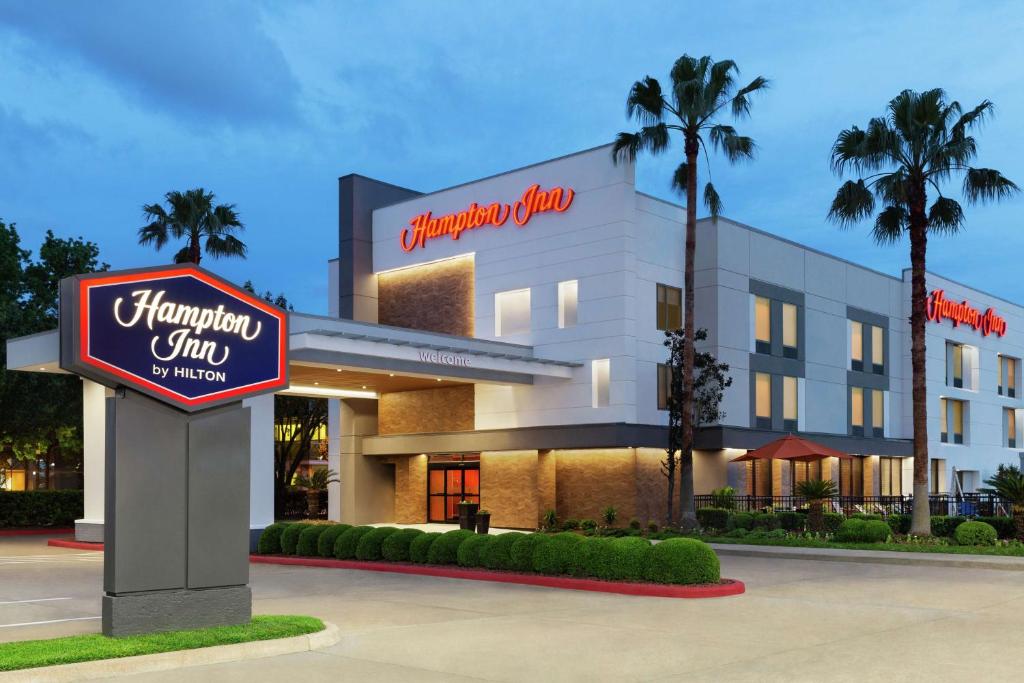 a hampton inn sign in front of a hotel at Hampton Inn - Houston/Brookhollow in Houston