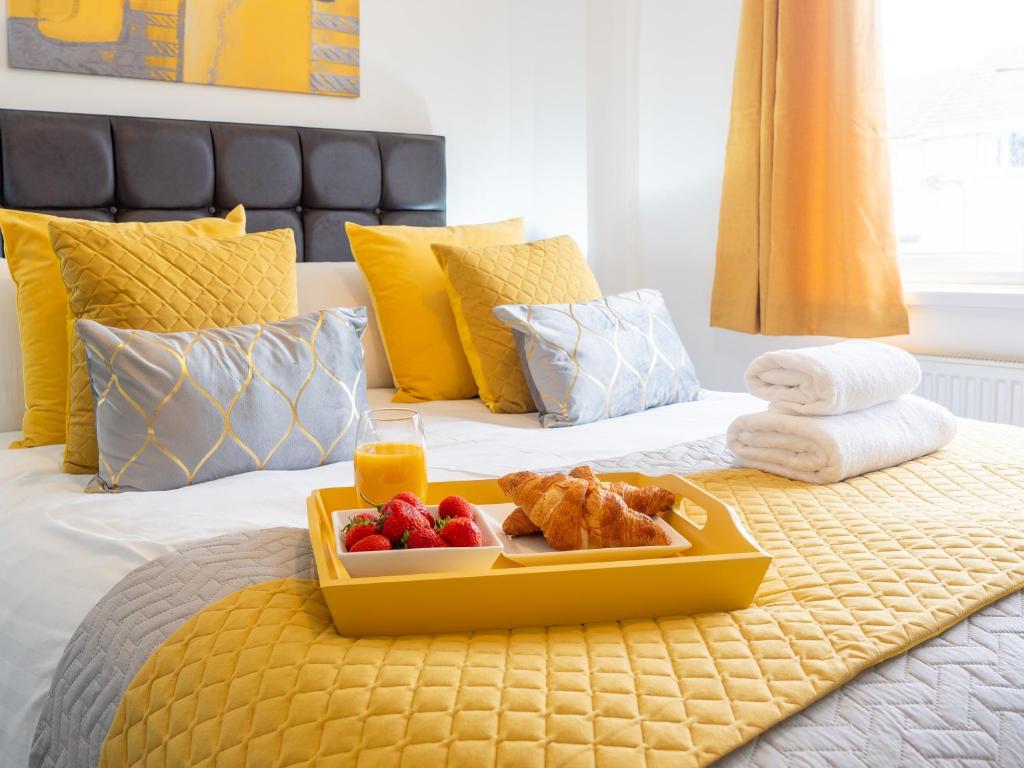 a tray of food and fruit on a bed at Mountain View Beautiful Large House By Cockermouth in Cockermouth