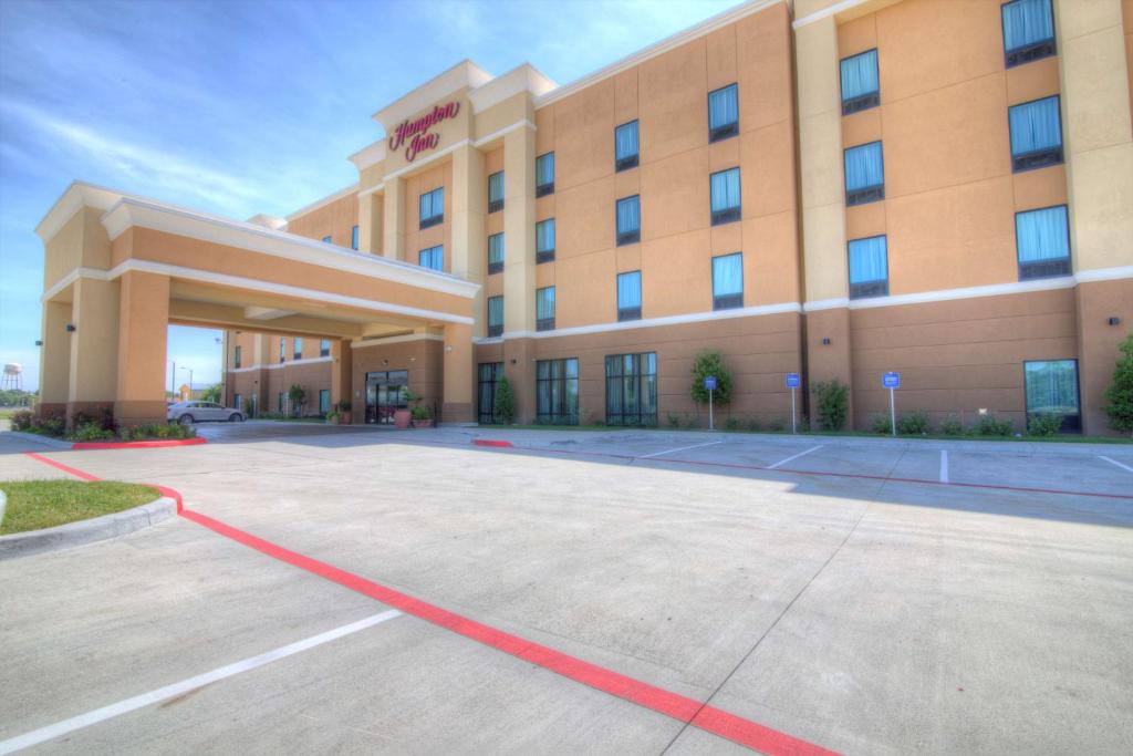 a hotel with a parking lot in front of it at Hampton Inn Houston I-10 East, TX in Houston
