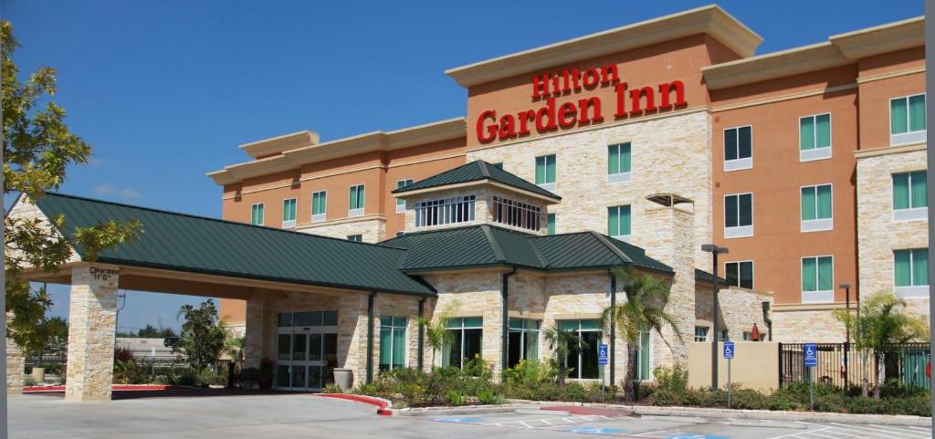 a hotel with a sign for a garden inn at Hilton Garden Inn Houston West Katy in Katy