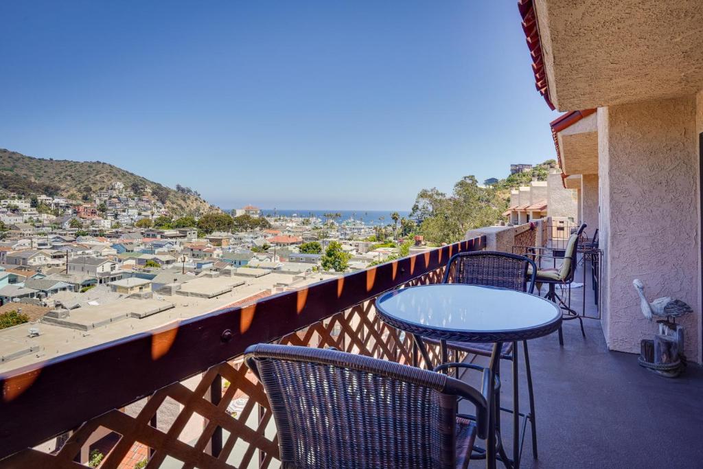 a balcony with tables and chairs and a view of a city at Family-Friendly Avalon Penthouse with Ocean View! in Avalon