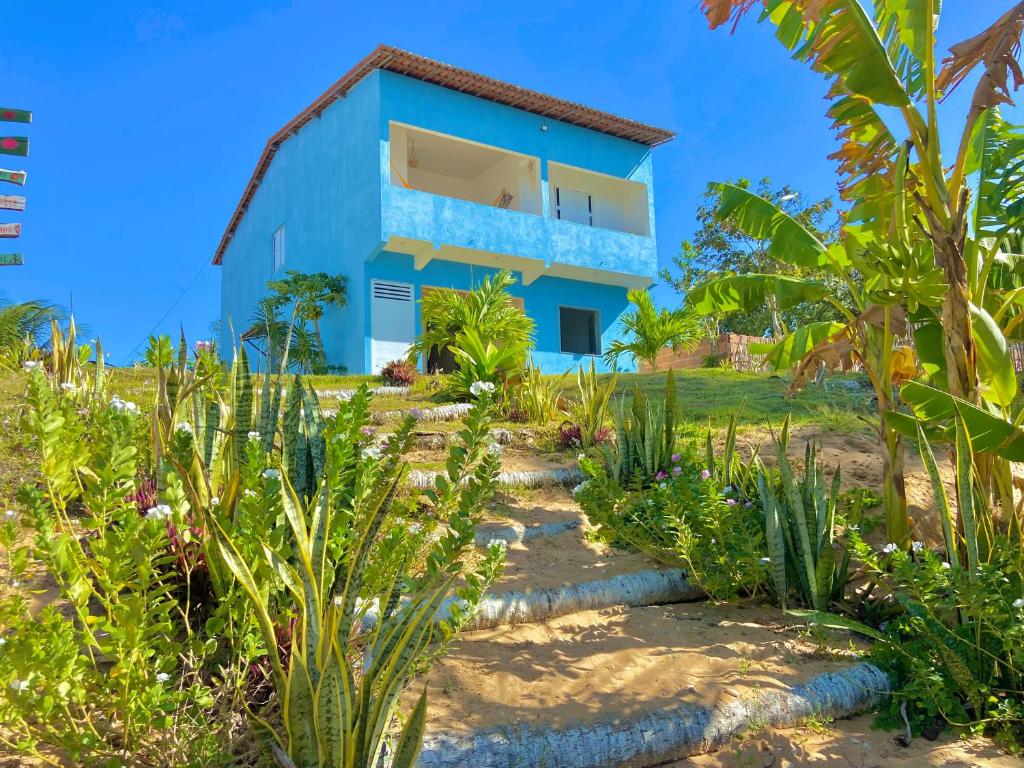 a blue house with plants in front of it at Casa Praia a Beira Mar Guriú Ceará in Guriú