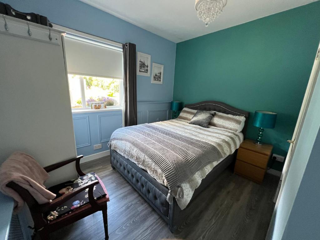 a bedroom with a bed and a window and a chair at Double bed Small En-suite for 2 in Killybegs