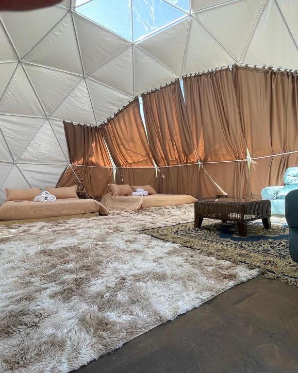 a room with a large tent with a large rug at Glamping Miraflores in Paihuano