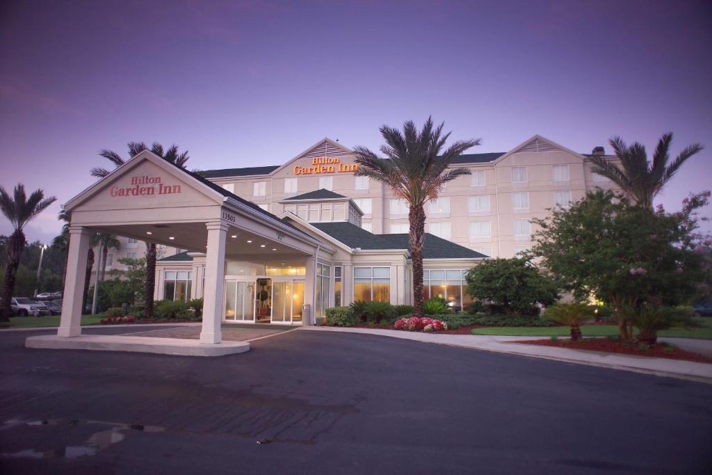 a hotel with a sign that reads the original inn at Hilton Garden Inn Jacksonville Airport in Jacksonville