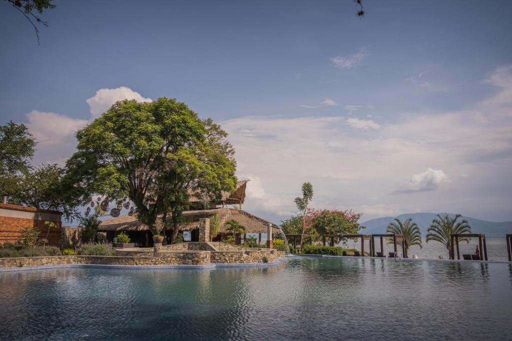 a pool of water in front of a house at Nimue Marina Residence in Ajijic