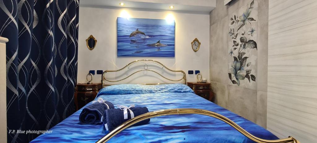 a bedroom with a bed with a blue comforter at Sea and Blue Sky 3 in Calimera